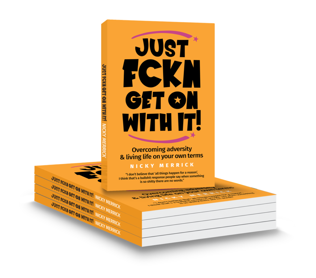 A stack of paperback copies of Just Fckn Get On With It by Nicky Merrick, with a bright orange cover